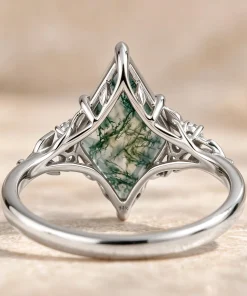 Back view of white gold kite moss agate leaf ring with an open botanical setting