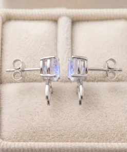 Side view of moonstone double-crescent studs showing posts and gemstone settings